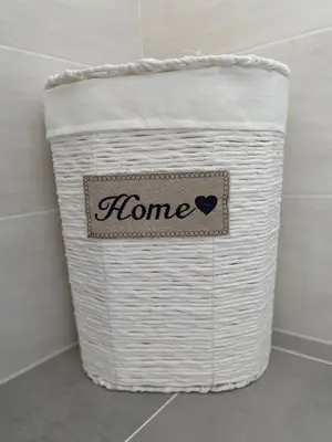 a white laundry basket with a home sign on it at Dany & Manu House in Rome