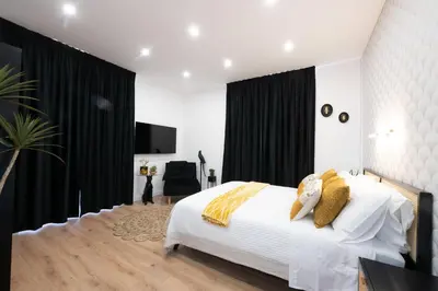 a bedroom with a white bed and black curtains at Sistine Chapel View Rooms Check-in From 3 Pm To 10 Pm in Rome