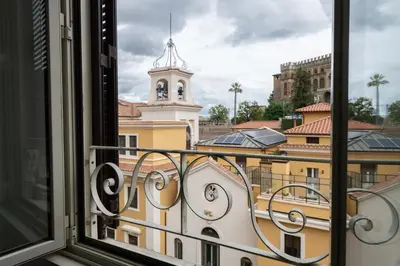 a view from a window of a building with a clock tower at Sistine Chapel View Rooms Check-in From 3 Pm To 10 Pm in Rome