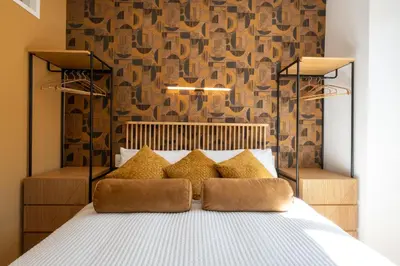 a bedroom with a bed with brown pillows at Sistine Chapel View Rooms Check-in From 3 Pm To 10 Pm in Rome