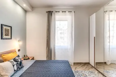 a bedroom with a bed and a large window at Appartamento Roma metro C Greghouse Centocelle in Rome