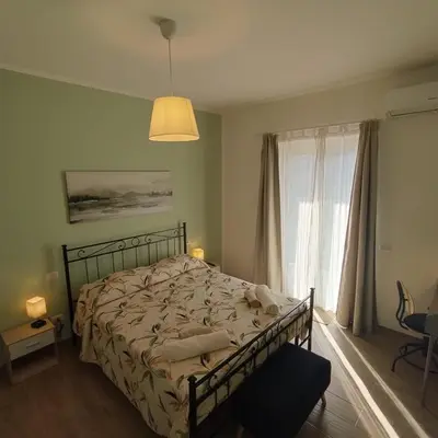 a bedroom with a bed and a large window at Caravaggio Inn in Rome