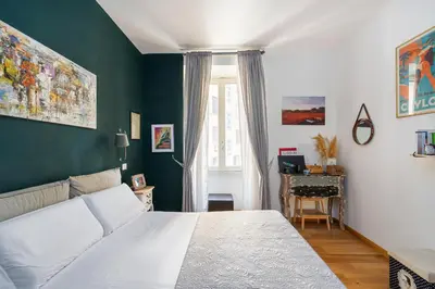 a bedroom with a white bed and a desk at Beautiful Apartment Rome Vaticano in Rome