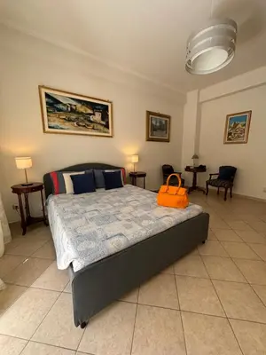 a bedroom with a bed with an orange bag on it at PR - appartamento in centro a Roma in Rome