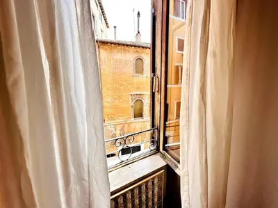 an open window with a view of a building at Benedetta house Trastevere in Rome