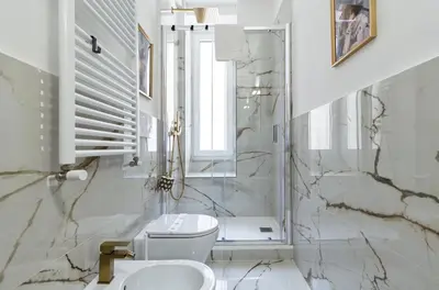a white bathroom with a toilet and a sink at AMOE - Eleganza e Storia nel Cuore di Roma in Rome