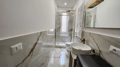a white bathroom with a sink and a toilet at AMOE - Eleganza e Storia nel Cuore di Roma in Rome