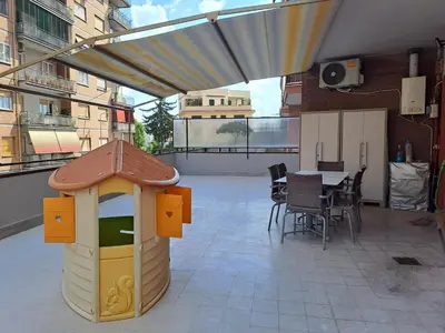 a childs play house on a balcony with a table at Mauri's Home - CasaMauri - Adiacente Metro C in Rome