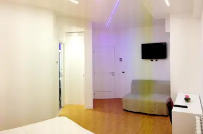 a room with a bed and a tv on a wall at Valle Aurelia House in Rome