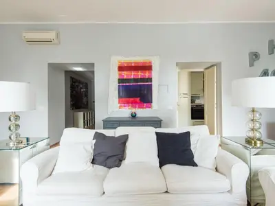 a living room with a white couch with pillows at Apartment La Casa dell'Arte by Interhome in Rome