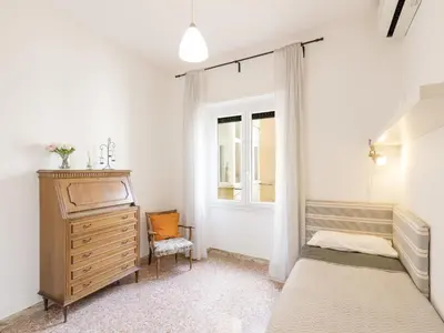 a bedroom with a bed and a dresser and a window at Apartment Appartamento Renato Roma Musei Vaticani by Interhome in Rome
