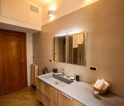 a bathroom with a sink and a mirror at Dimora al Colosseo, 2 bedrooms in Rome