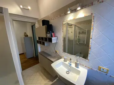 a bathroom with a sink and a mirror at Casa Tua a Roma Centro con box auto tra Stadio Olimpico e Vaticano in Rome