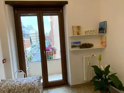 a room with a door leading to a balcony at Casa Tua a Roma Centro con box auto tra Stadio Olimpico e Vaticano in Rome