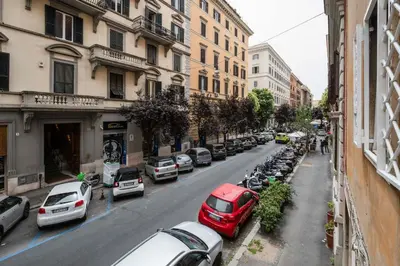 a street with cars parked on the side of the road at Palazzo Piazza Cavour-ZEN62 in Rome