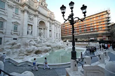 a fountain in a building with people walking around it at Stunning Pantheon Apartment in Rome