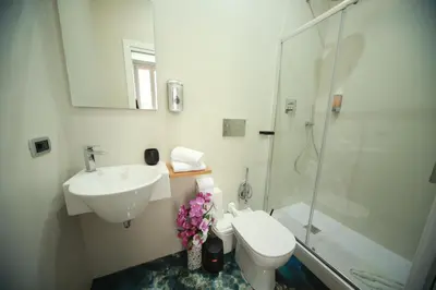 a bathroom with a sink and a toilet and a shower at Vacanze Romane Vaticano in Rome