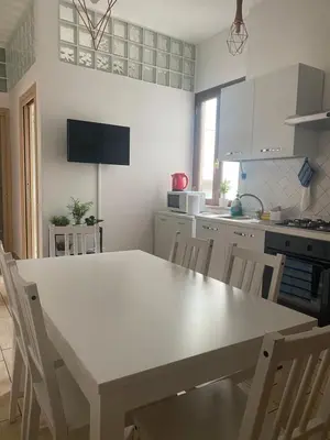 a kitchen with a white table and chairs at Fall in love with Roma Vaticano - 5 Minutes from the Vatican - balcony with a view in Rome