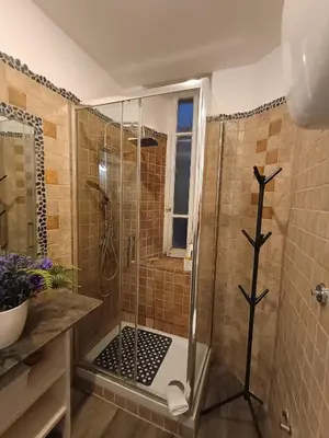 a bathroom with a shower with a glass door at Po49 Appartamento in Rome