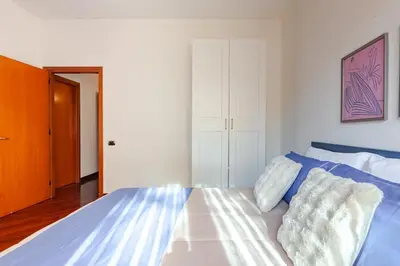 a bedroom with a bed with blue and white sheets at Modern & Cozy Double Rooms, Private bath WIFI AC in Rome