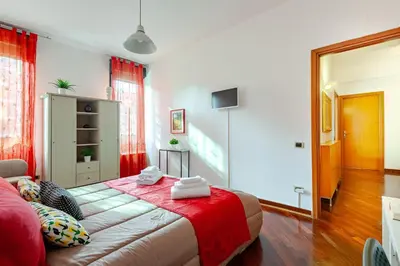 a bedroom with a bed and a red blanket at Modern & Cozy Double Rooms, Private bath WIFI AC in Rome