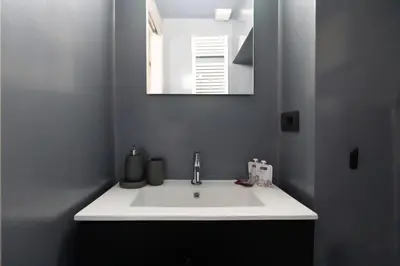 a white sink in a bathroom with a mirror at Margutta Exclusive Apartment by Romeloft in Rome