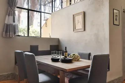 a dining room with a wooden table and chairs at Margutta Exclusive Apartment by Romeloft in Rome