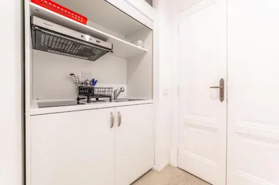 a kitchen with white cabinets and a sink at La Casa di Lidia - Vatican City Metro Ottaviano in Rome