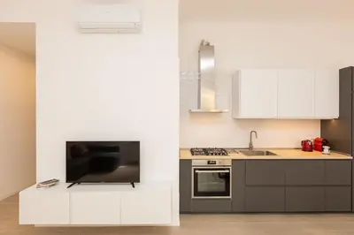 a kitchen with white cabinets and a sink at Mastai Trastevere Home by Rental in Rome in Rome