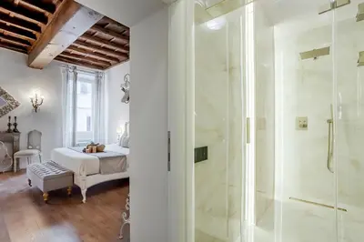 a bathroom with a shower and a bedroom with a bed at Trevi Fountain Elegant Apartment in Rome