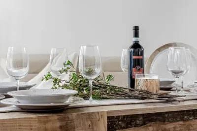 a table with wine glasses and a bottle of wine at Trevi Fountain Elegant Apartment in Rome