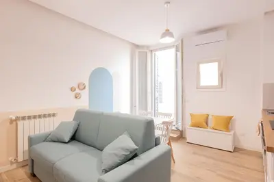 a living room with a couch and a chair at Alba Terrace - Rome Modern Apt Close to Metro in Rome