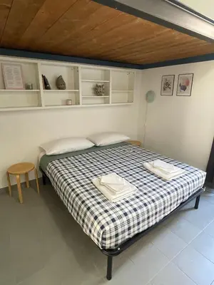 a bedroom with a bed with two towels on it at Blueberry House in Rome