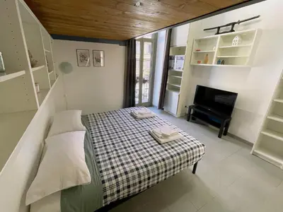 a small bedroom with a bed and a piano at Blueberry House in Rome