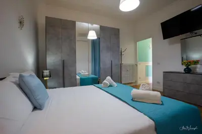 a bedroom with a large white bed with towels on it at Vatican Roof Luxury Tiffany terrasse privée in Rome