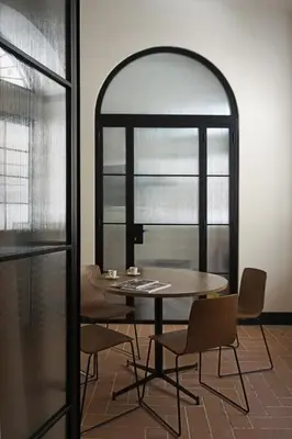 a table and chairs in a room with a window at La Corte Dei Panni in Rome