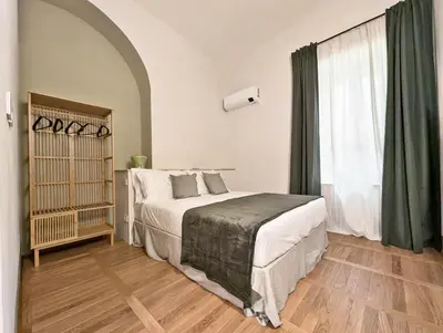 a bedroom with a bed and a large window at La Corte Dei Panni in Rome