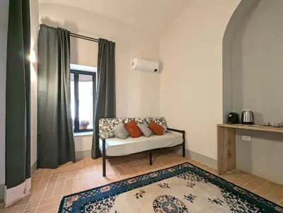 a living room with a couch and a window at La Corte Dei Panni in Rome