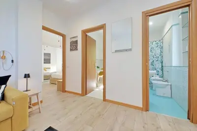 a living room with a door leading to a bathroom at Parioli Apartment self check in in Rome