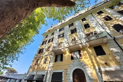a large yellow building with a balcony at Parioli Apartment self check in in Rome