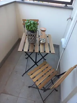 a table with a potted plant and a bench at Andrew's Suite Rome center in Rome