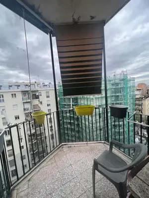 a balcony with a chair and a view of a city at Nathan House, Malatesta in Rome