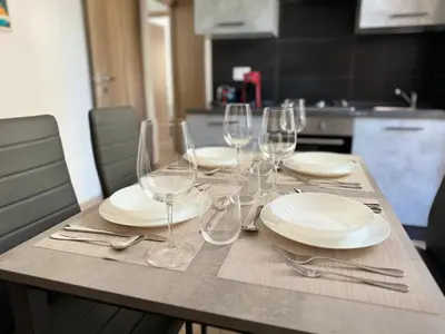 a table with plates and wine glasses on it at House Garden 44 - 15 minutes from Vatican Museums in Rome