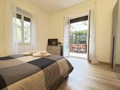 a bedroom with a bed and a door to a patio at House Garden 44 - 15 minutes from Vatican Museums in Rome