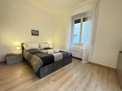 a bedroom with a large bed and a window at House Garden 44 - 15 minutes from Vatican Museums in Rome