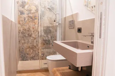 a bathroom with a shower and a sink and a toilet at Maison Vaticano - A few steps from Vatican and San Peter in Rome