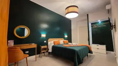 a bedroom with a large bed and a blue wall at IAIO Testaccio Retrò in Rome