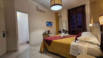 a bedroom with a large bed and a tv at IAIO Testaccio Retrò in Rome