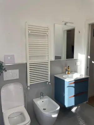 a bathroom with a white toilet and a sink at Enjoy Rhome in Rome