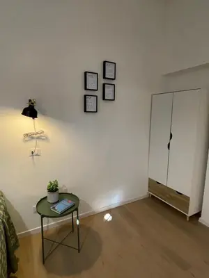 a living room with a table and a white wall at Enjoy Rhome in Rome